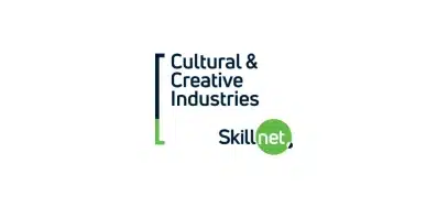 Logo for Cultural & Creative Industries Skillnet, inspired by the Kilkenny Animated Festival, featuring the organisation’s name in blue text with a green bracket and a green circle behind the word “net.”.