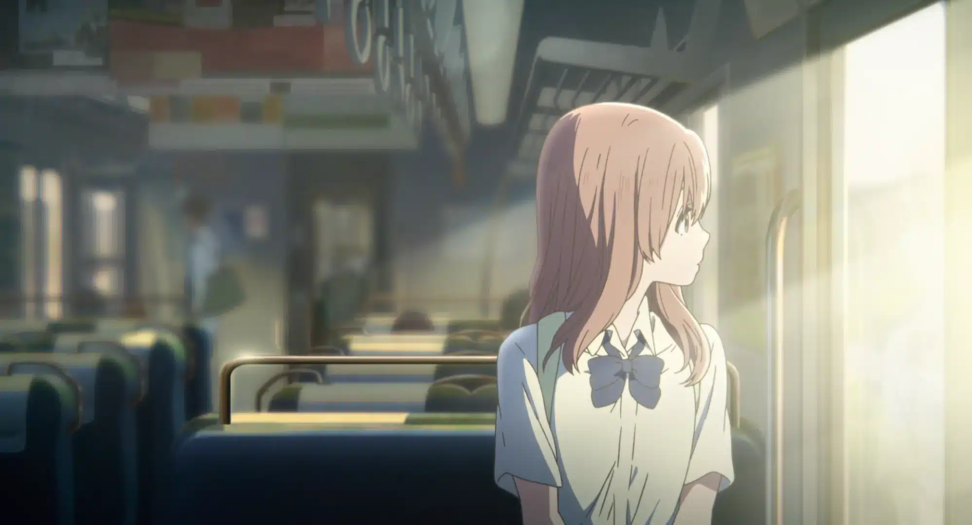 Anime girl with light brown hair in a school uniform sits alone on a train, looking out of the window as sunlight streams in. The train appears mostly empty, with blurred figures in the background.