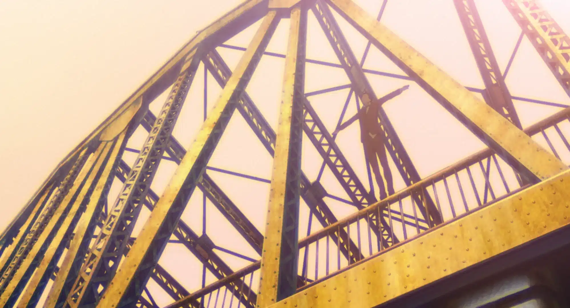 A person stands on a yellow metal bridge surrounded by beams and trusses, silhouetted against a bright, hazy sky.